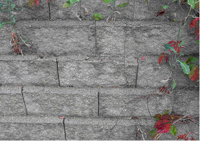 Figure 19. Photo. Deterioration of exposed vertical surfaces of SRW blocks. Picture shows macrocracking on the upper edges of the SRW blocks.