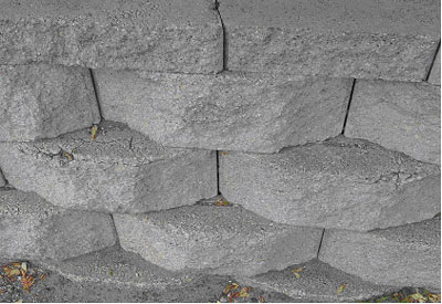 Figure 20. Photo. Another example of deterioration of exposed horizontal surfaces of SRW blocks. Picture shows scaling and cracking on SRW blocks.