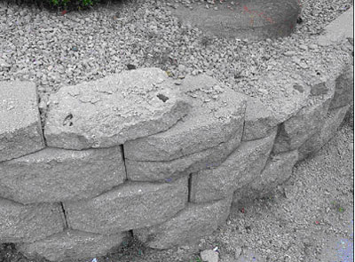 Figure 23. Photo. Blocks obtained from SRW in Minnesota (MN-4). Picture shows SRW wall with scaling and deterioration of blocks.