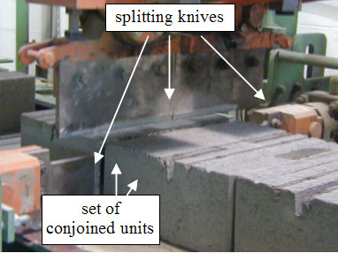 Figure 30. Photo. Splitting of conjoined units. Picture has arrow pointing to splitting knives on equipment and the set of conjoined units.