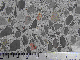 Figure 7. Photos. Comparison of internal structures between SRW and ordinary concretes. Photo b shows Ordinary concrete. Picture is of a smooth surface of concrete block measuring approximately 8 inches from ruler at bottom.