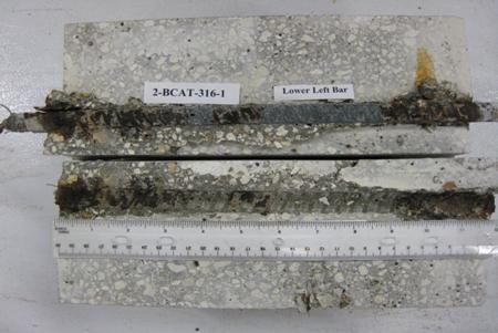 Figure 90. Photo. Lower L BB and bar trace of specimen 2-BCAT-316-1 subsequent to dissection. This is a photograph of lower L BB and bar trace of specimen 2-BCAT-316-1 subsequent to dissection showing extensive corrosion of this bar.