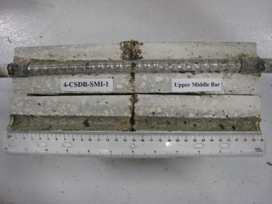 Figure 96. Photo. Top C bar and bar trace of specimen 4-CSDB-SMI-1 subsequent to dissection. This is a photograph of a top C bar and bar trace of specimen 4-CSDB-SMI-1 subsequent to dissection showing corrosion at clad defects.