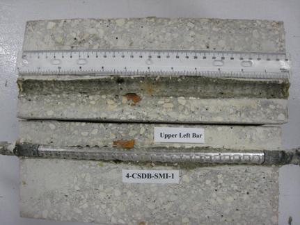 Figure 98. Photo. Top L bar and bar trace of specimen 4-CSDB-SMI-1 subsequent to dissection. This is a photograph of top a L bar and bar trace of specimen 4-CSDB-SMI-1 subsequent to dissection showing corrosion at clad defects.