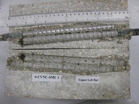 Figure 104. Photo. Top L bar pair and bar pair trace of specimen 6-CVNC-SMI-1 subsequent to dissection. Photograph of a top L bar pair and bar pair trace of specimen 6-CVNC-SMI-1 subsequent to dissection. Corrosion is apparent at the bar ends.