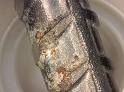 Figure 111. Photo. Localized corrosion on the top bent bar from specimen MS-CBNB-316-B. This is a photograph of localized corrosion on the top bent bar from specimen MS-CBNB-316-B.