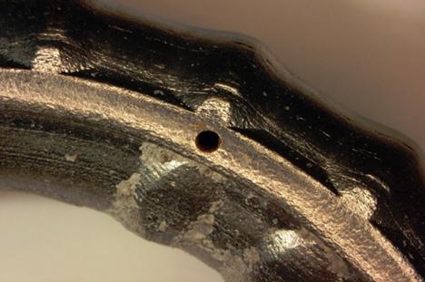 Figure 113. Photo. Corrosion at a second intentional clad defect on the top bent bar from specimen MS-CBDB-SMI-B. This is a photograph of corrosion at a second intentional clad defect on the top bent bar from specimen MS-CBDB-SMI-B.