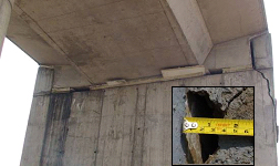 Photo. Shear key damage at entrance ramp abutment. Click here for more information.