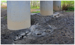 Photo. Sand boils near columns at west end of Llacolen bridge. Click here for more information.