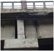 Photo. Spalling in deck slab at west end of Llacolen bridge. Click here for more information.