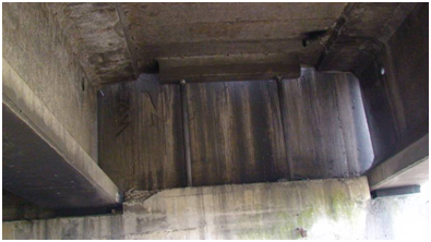 Photo. Spalling of shear key at southwest abutment of Llacolen bridge. Click here for more information.
