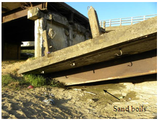 Photo. Sand boils near collapsed span in west Ramadillas bridge. Click here for more information.