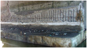 Photo. Spalling due to shear action and vertical crack in Tubul bridge. Click here for more information.