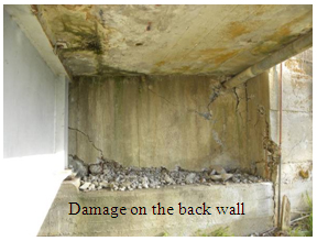 Photo. Damage to north abutment back wall of El Bar bridge. Click here for more information.