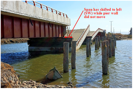 Photo. Collapsed and shifted spans at Raqui 2 bridge as viewed from base of southeast abutment. Click here for more information.