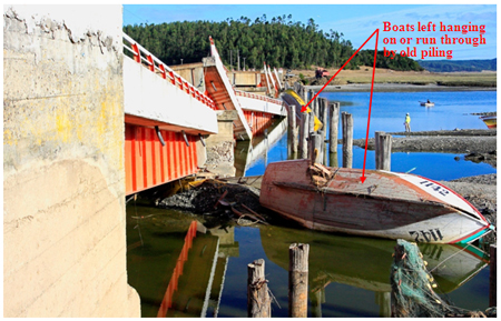 Photo. Tubul bridge with boats run through by old timber pilings. Click here for more information.