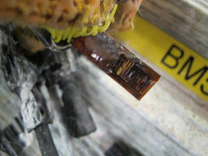 This photo shows a close-up view of a corroded linear polarization resistance (LPR) sensor 5. The sensor is misshapen and main portion of the electrodes have experienced ferrous corrosion. 