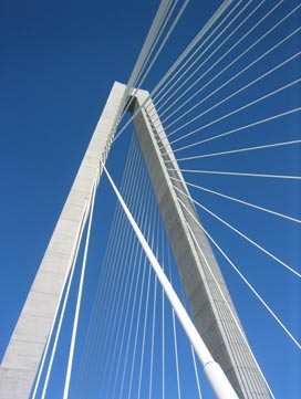 This photo shows modern stay cables with high-density polyethylene (HDPE) tube cover on the Clark Bridge. Two fans of cables span from an A-shaped tower. The entire length of cables is covered by a white HDPE tube cover.