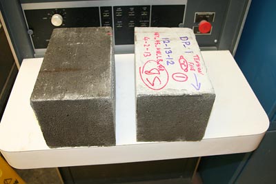 The photo shows bond failure right at the grout-concrete interface from a bond flexural test using 6- by 6- by 21-inch (152.4- by 152.4- by 533.4-mm) prism specimens.