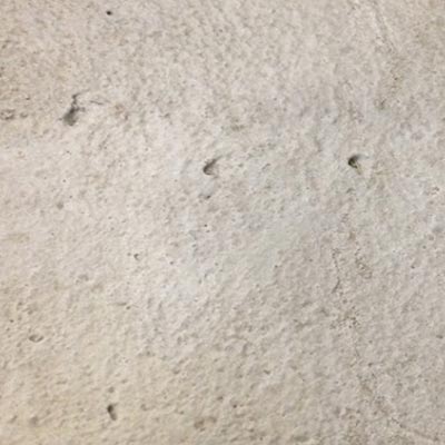 The photo shows the type of concrete surface obtained with sand blast surface preparation methods, characterized by having a low-to-medium degree of roughness.