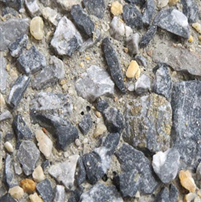 The photo shows the type of concrete surface obtained with a large concentrated (in-form) retarder, where all of the coarse aggregate particles are exposed after pressure washing the paste and sand fractions of the concrete surface.