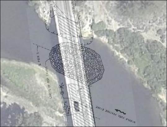 Figure 26. Photo. Rock layout design for protection of pier 3. This aerial photo shows the river and bridge with the rock layout extent superimposed. The riprap apron covers most of the river bottom at the bridge crossing.