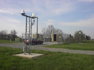 Figure 3.  The Hagerstown Ashtech and Trimble Antennas Photo.  This photograph shows the two NDGPS equipment huts and the two antenna masts.  Each antenna mast contains one GPS antenna and one integrity-monitoring antenna.