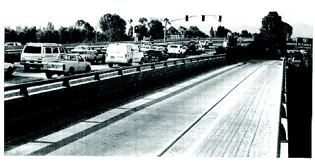 Figure 3-13. Freeway mainline metering at El Cajon, CA. Photograph of three lanes of State Route 67 that are metered as they join westbound Interstate 8.