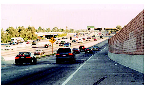 Figure 3-14. Freeway-to-freeway metering at the junction of the I-105 and I-605 freeways in Norwalk, CA. Photograph of signals acting as traffic flow meters on two lanes of Interstate 105 that allow three vehicles per lane during each green cycle to enter the four lanes of Interstate 605.