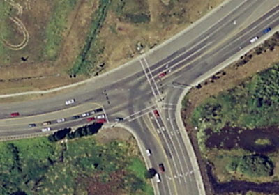 The picture shows a T-intersection with crosswalks and double left- and right-hand turn lanes that accommodate high-volume turning movements. 