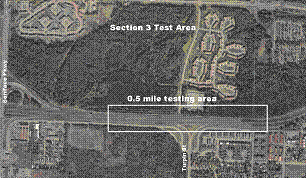 Figure 22.  Photograph.  Test section 3.  An aerial photograph illustrates the location of test section 3 on the Glenn Highway State Route 1 outside Anchorage, AK.  The testing area is located on a straight section of the highway, which runs left to right in the photograph, with the northbound lanes on the bottom.  There is an interchange with Turpin Road and the northbound lanes of the Glenn Highway at the midpoint of the test section.  The test section is approximately 0.5 mi long.