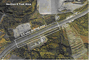 Figure 27.  Photograph.  Test section 9.  An aerial photograph illustrates the location of test section 9 on the Glenn Highway State Route 1 outside Anchorage, AK.  The testing area is located on a straight section of the highway immediately after a right hand curve at the left, bottom corner of the photograph.  The test section is approximately 0.5 mi long.