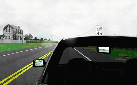 Figure 5. Screenshot. Left outside and center-mounted rear view mirrors viewed from behind the vehicle. This screenshot is taken from the back of the vehicle and shows a simulated highway scene in the background. Where the left side view mirror and center high-mounted mirror would be located in a standard vehicle, LCD displays portray images of the simulated world behind the vehicle.