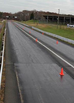 Figure 40. Photo. Layout of course on drag strip. This figure shows a two-lane drag strip with cones dividing the lanes.