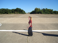 Figure 10. Photo. Training example with pedestrian facing left. This photo shows the photograph cutout of a pedestrian facing left in a crosswalk spanning a two-lane road. The instructions below the photo state, "When the pedestrian in the crosswalk is moving to the left (as shown) please press (3) (do so now)."