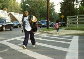 Three pictures are shown. All the pictures are of smiling children crossing at crosswalks.
