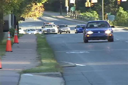 Photo. Motor vehicle position in the uphill direction after the sharrow. Click here for more information.