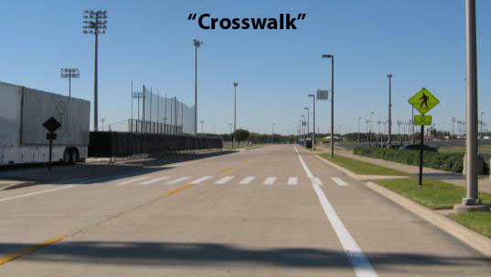 This figure is a slide included in the training slide show. The photograph shows a midblock continental crosswalk marking. The word "Crosswalk" is included in quotes in a white box on the top portion of the photo. This slide was intended to provide an example of one of the traffic features participants were asked to identify during the study.