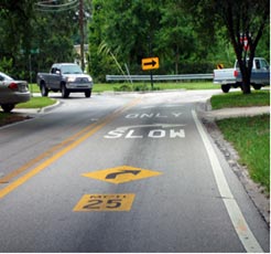 Two lane street with slow warnings