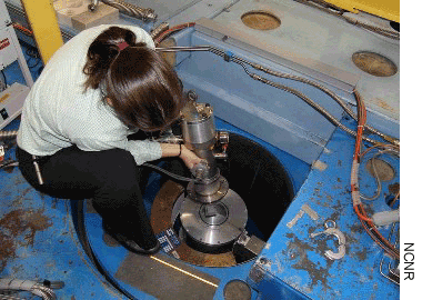 Dr. Vanessa Peterson is shown preparing equipment used to collect data on cement at the National Institute of Standards and Technology's Center for Neutron Research. (Photo credit: NCNR)