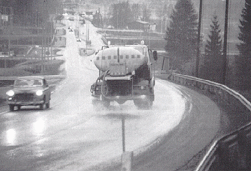 Photo of truck applying liquid to prevent road from becoming icy.