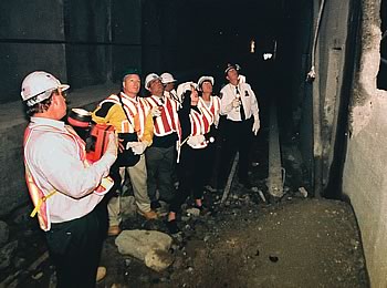 Photo showing workers inspecting a subway project.