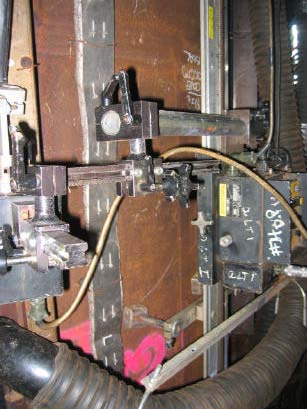 Figure 6: Automated FCAW equipment and electric heat strips at partially welded pile connection plate weld.