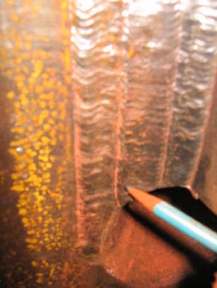 Figure 14: Magnetic particle indication at pile connection plate weld location 2C (Weld 2), between weld beads. Indication removed by light grinding, no flaw detected.