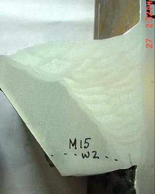 Figure 25: Sample M15 from Weld 2 in sample 5D. Note crack in root pass extending from bottom of root to middle of root. Dashed line shows boundary of heat affected zone from gas cutting during sample removal.