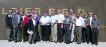 Image of people standing in front of a wall.
