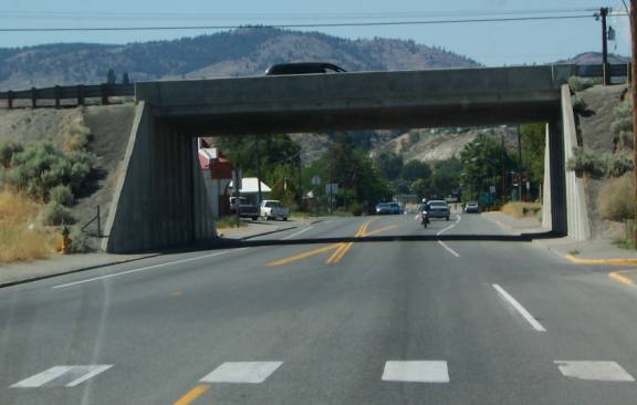 photo of a two lane road at with an overpass