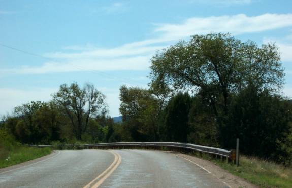 photo of a two lane road with guardrail