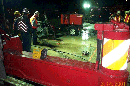 Photo showing the saw cutting and the removal of the existing concrete deck of the James River Bridge.