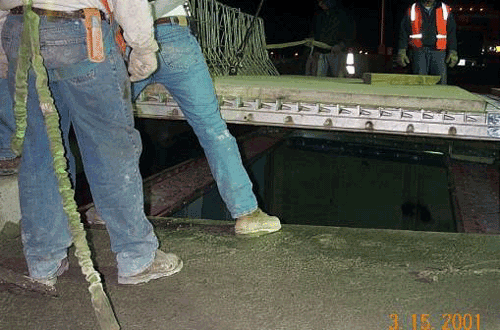 Photo showing placement of the new concrete-filled grid deck on the James River Bridge.